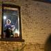 Pedestrians watch festivities from an upper level window in Kerrytown on Sunday. Daniel Brenner I AnnArbor.com